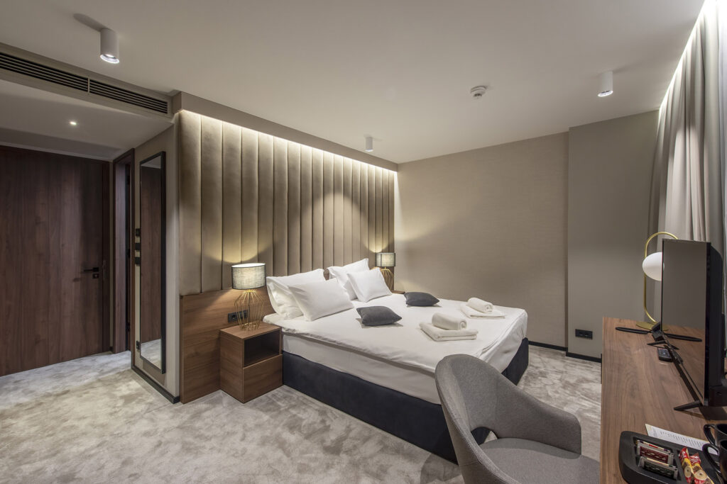 Elegant hotel bedroom with acoustic carpet for superior comfort